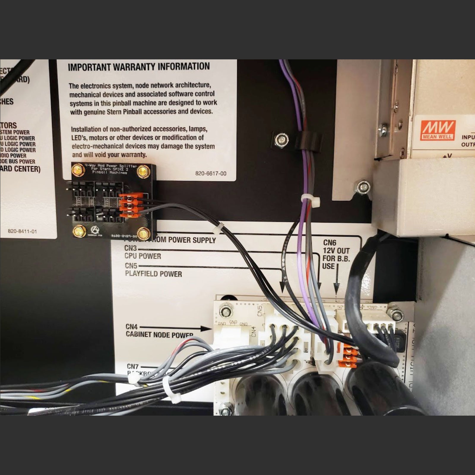 Nitro Pinball Sales Parts & Accessories 4-Way Power Splitter Board for Stern SPIKE & SPIKE 2 Pinball Machines – Clean Mod Power Hub Close-up of electronic equipment with wiring and a label on a black background